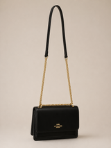 BOLSA COACH NEGRA CON CADENA DORADA